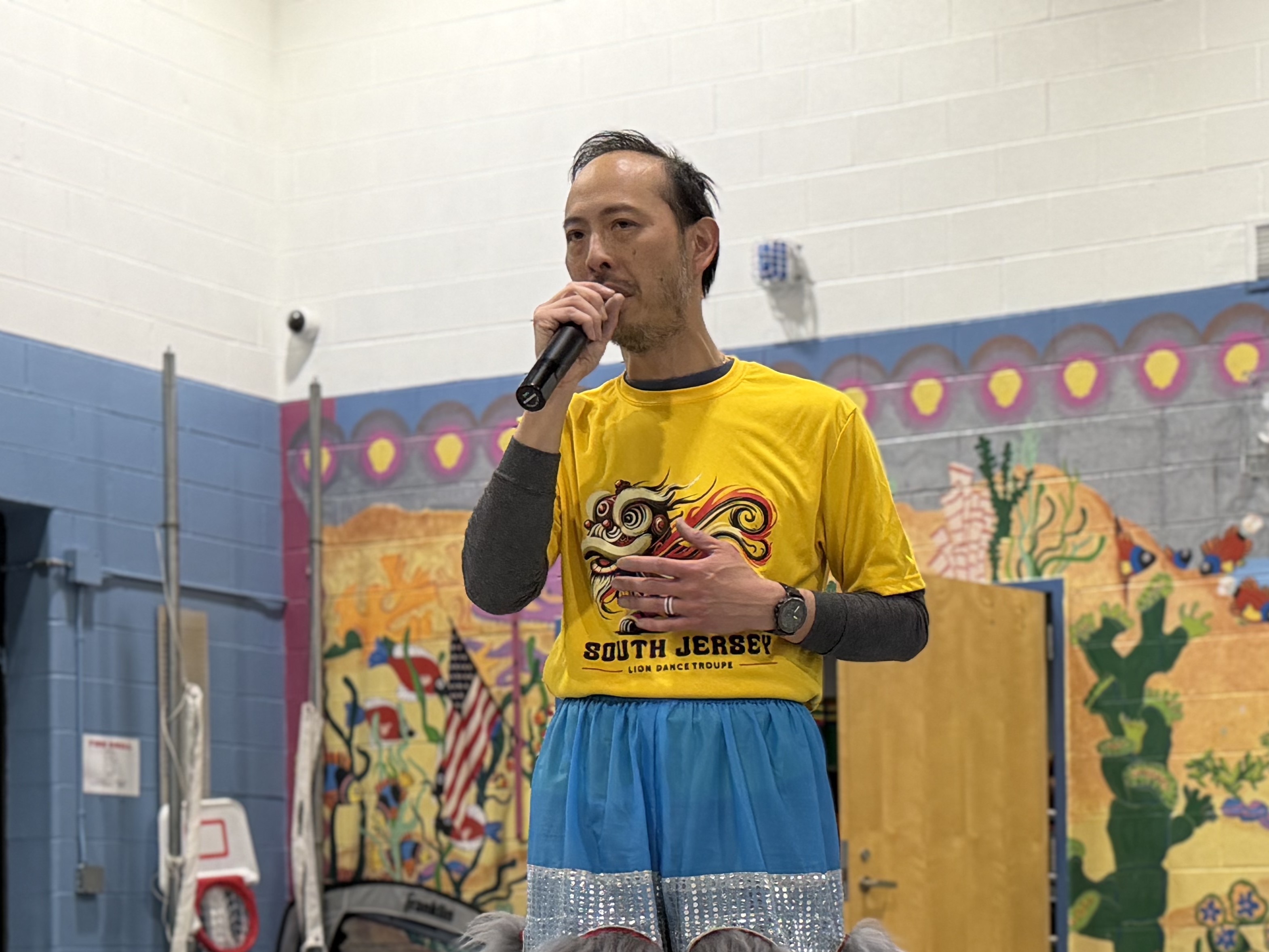 Coach Joe speaking at a performance