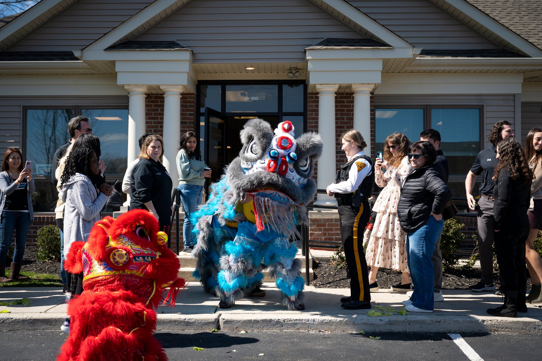 Lion dancers performing outside a community building