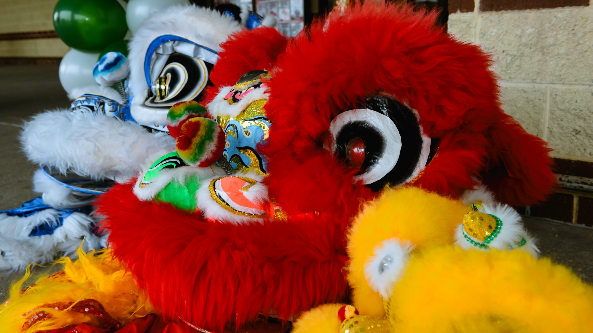 Two lion dance heads side by side