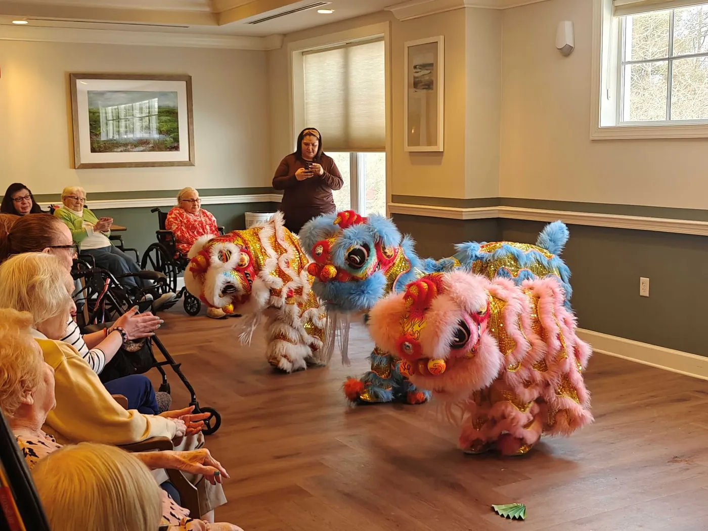 Young Bao Bao Lions performing for residents in a senior center common room